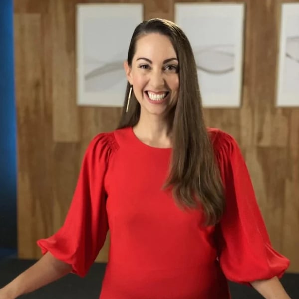 Vanessa Van Edwards smiling in red top