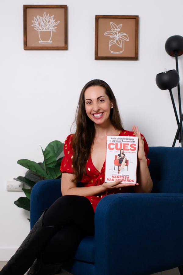 Vanessa Van Edwards holding Cues book