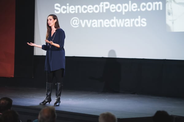 Vanessa Van Edwards on stage with ScienceofPeople brand slide