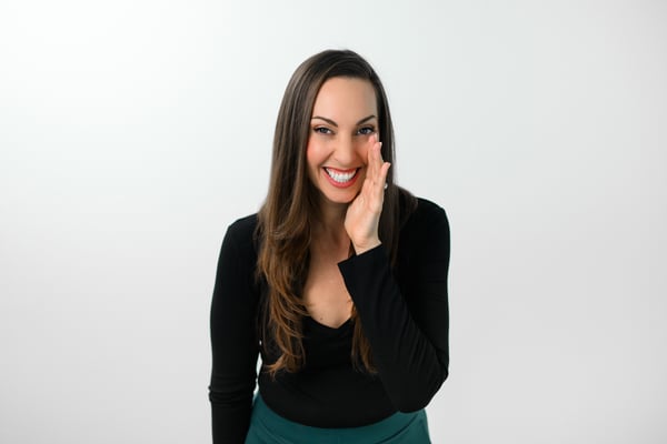 Vanessa Van Edwards laughing with hand on cheek