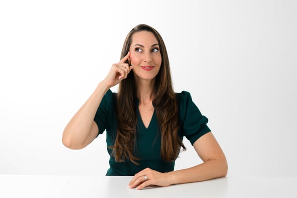 Vanessa Van Edwards studio portrait with thinking gesture