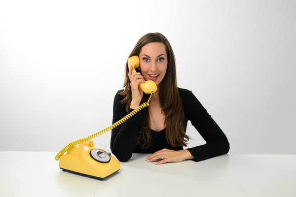 Vanessa Van Edwards with vintage yellow rotary phone