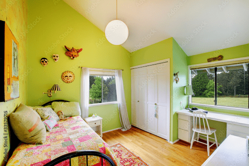 An image of a brightly colored green room which represents the study that showed that when given a task that required a steady attention span, participants performed notably better when taking short breaks to look at green roofs versus concrete roofs. This is an example of color psychology.