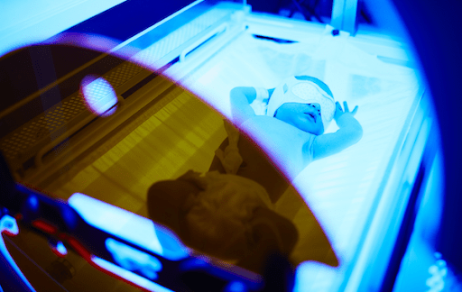 An image of a baby in a blue-green light that has pre-natal jaundice, which helps purify the baby’s blood and heal their jaundice. This shows how color psychology affect our health even when our eyes are shut.
