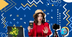 A woman looking at a camera on a tripod with her lips parted. In one hand she is holding up a passport, and the other she has her palm facing the camera. She is also wearing a hat, and there is a globe and a laptop near her, which relates to the article on travel tips.