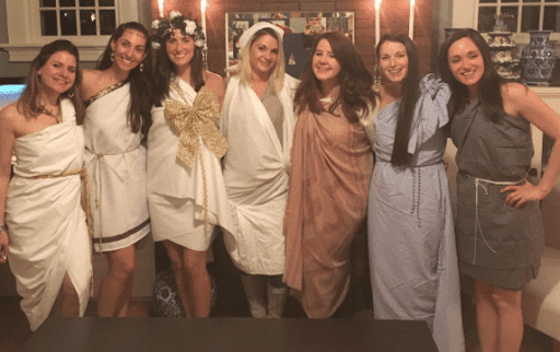 An image of Vanessa Van Edwards and all of her friends as a Christmas toga party, which relates to the article on how to make friends as an adult.