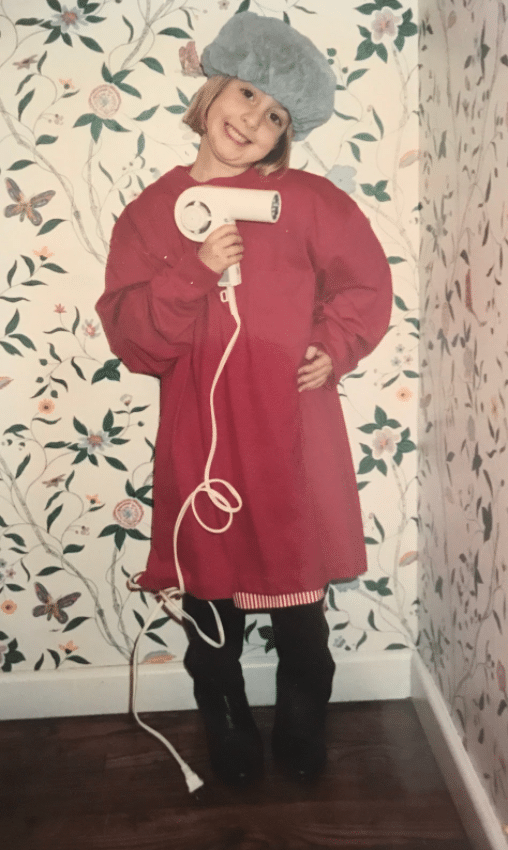 Vanessa's picture of herself when she was young, holding a hair dryer