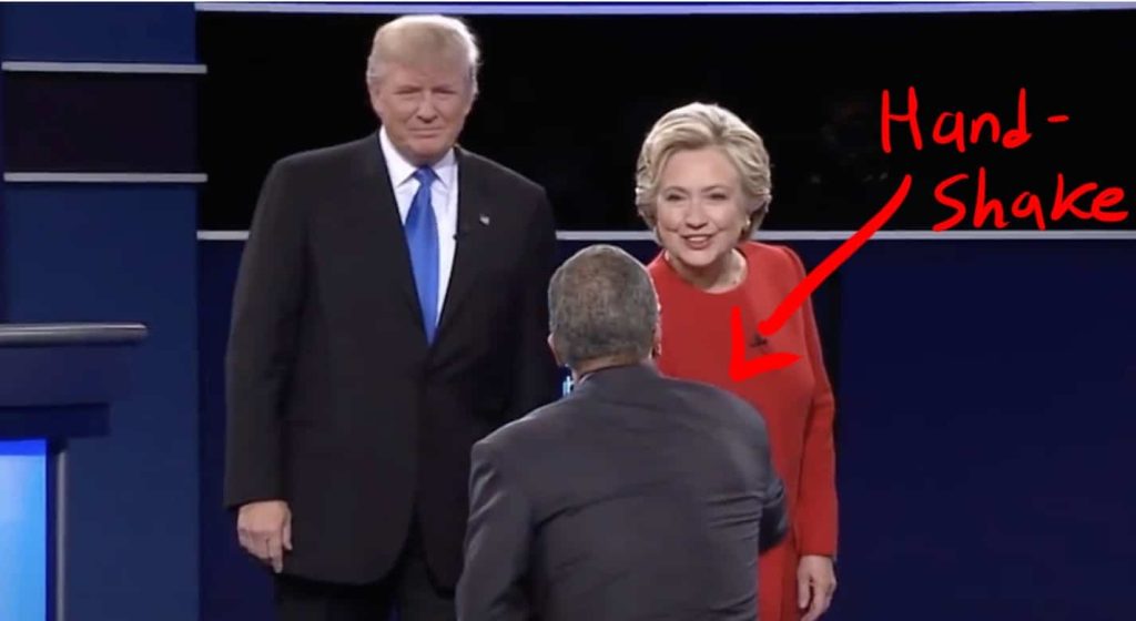 Clinton shakes the moderator's hand.