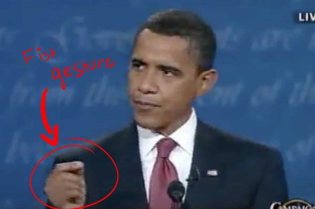 Obama makes his signature hand gesture.