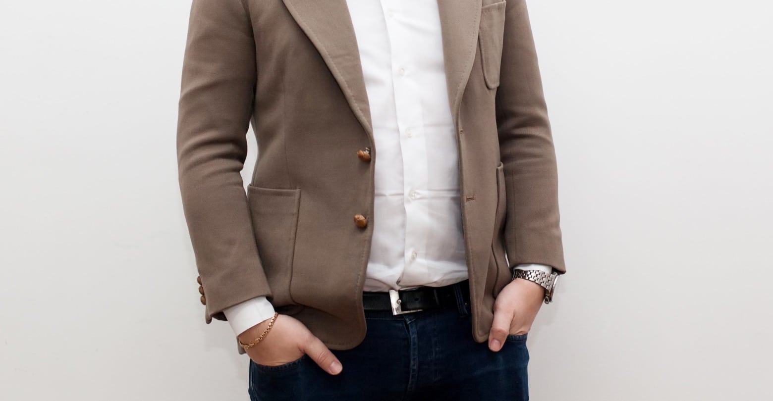 Body Language image of a man with his thumbs out of pockets