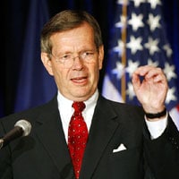 Department of Health and Human Services Secretary Michael Leavitt speaks while sand pinching