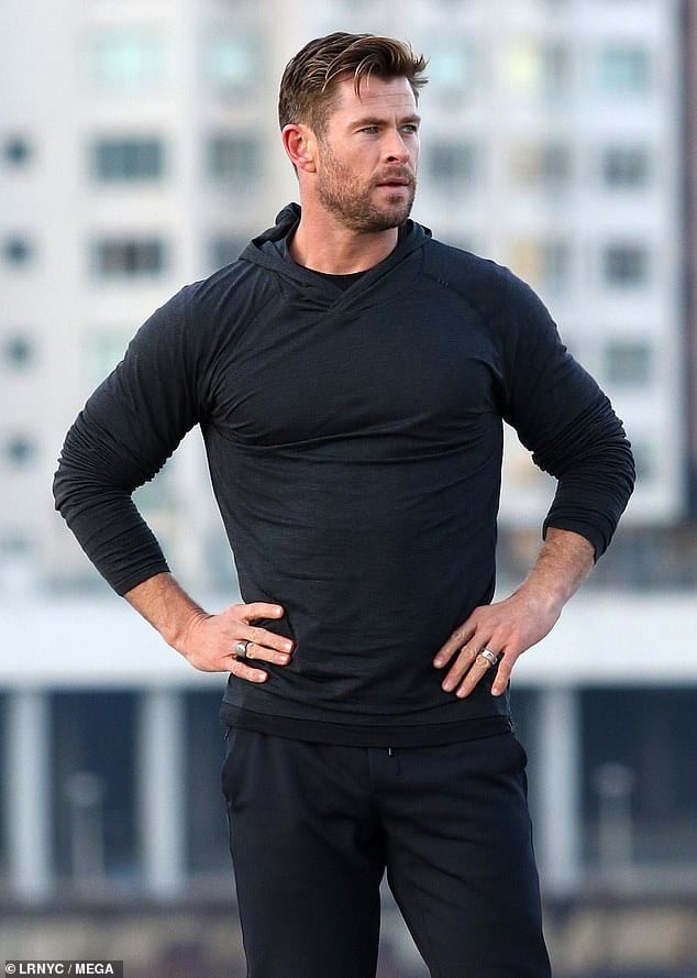 Chris Hemsworth posing with his hands on hips