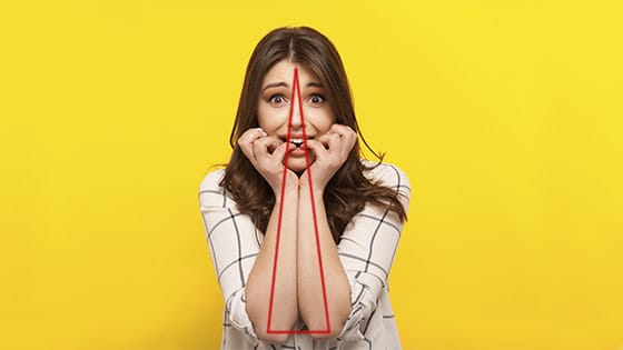 Woman sitting with her elbows in a small triangle postion