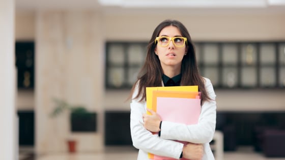 Nervous Schoolgirl holding her book with her arms corssed