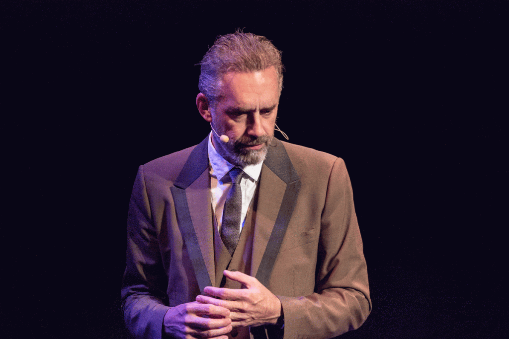 Jordan Peterson spinning his ring as he gives a speech on stage