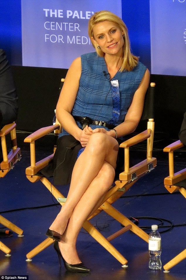 Claire Danes seated parallel legs