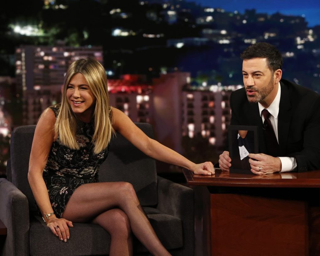 Jennifer Aniston Plays at Jimmy Kimmel show crossing her legs