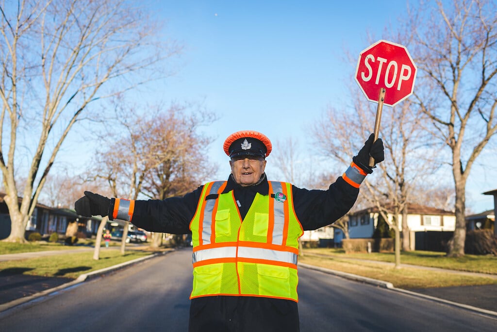 crossing guard showing Stop sign