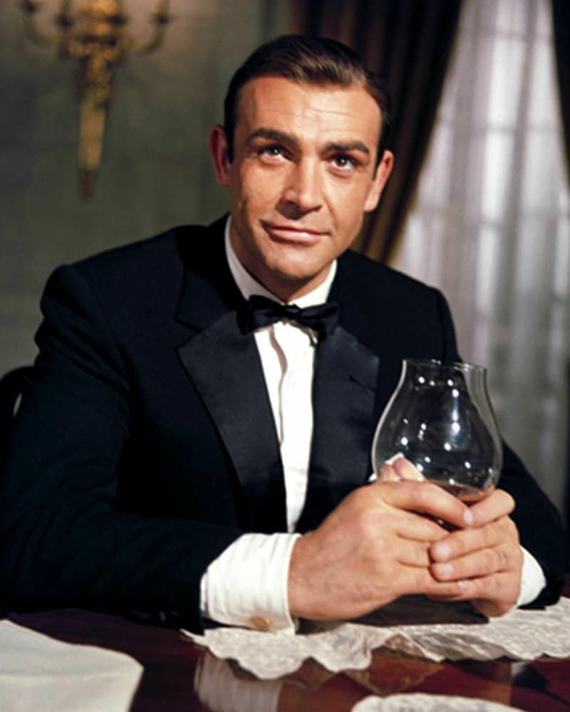 Sean Connery holding a glass in his hands