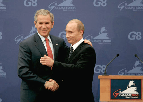 Former US President George W. Bush in the power position with his hand on the back of Russian president Vladimir Putin