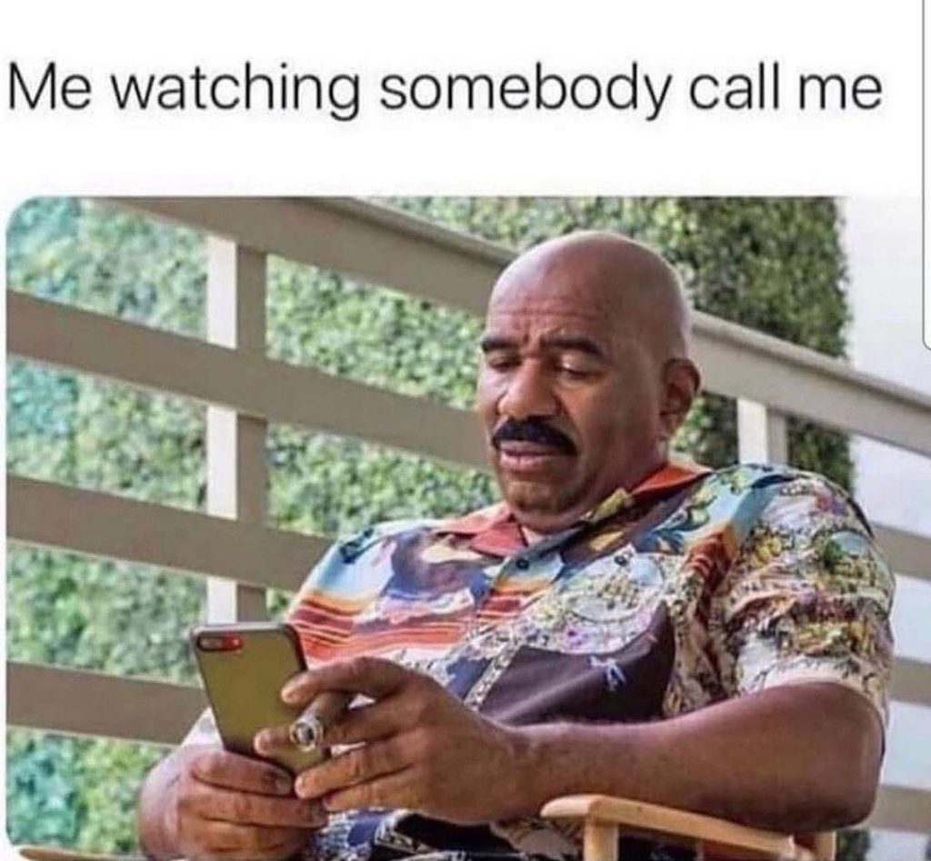 A picture of a man blankly staring at his phone, with a text above that says "Me watching somebody call me"