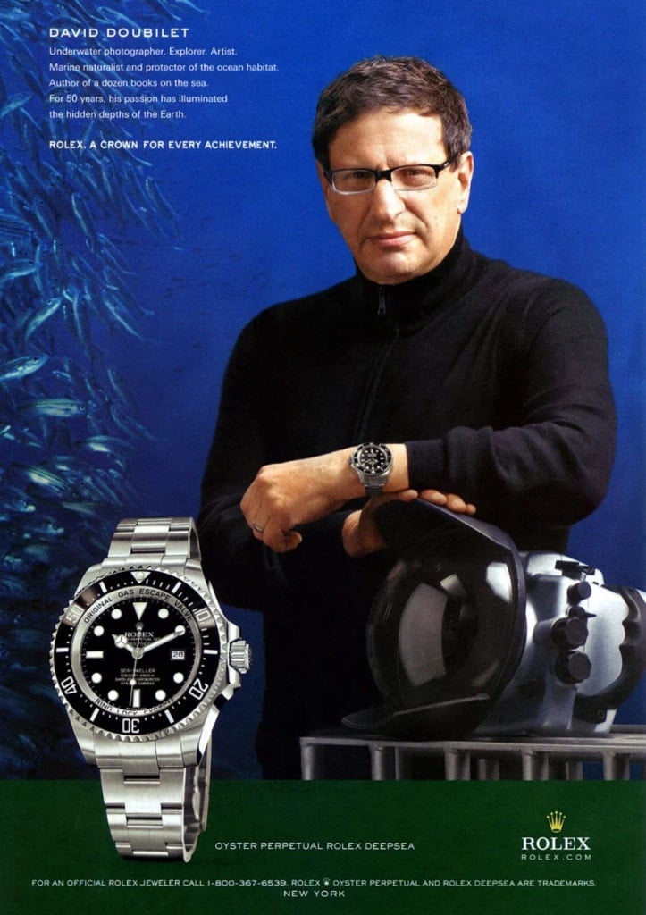 Image of a Rolex ad, the man in it is wearing a black turtleneck sweater and a rolex