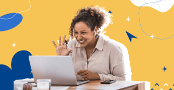 Happy woman facing her laptop screen