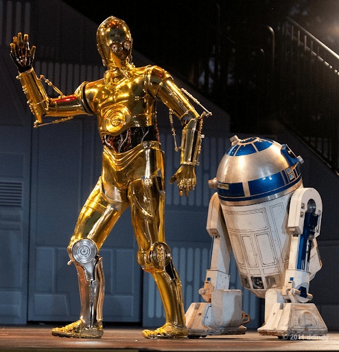 An image of C-3PO and R2D2 from star wars. C-3PO has a silver leg, which most people don't remember. This is an example of the mandela effect.