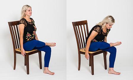 A woman is sitting in a chair doing a seated hip flexor stretch called pigeon pose as an office exercise
