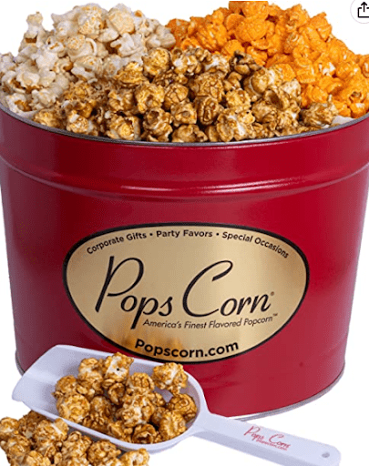 Assorted popcorn tins with kettle, cheddar, caramel, and other flavors from Pops Corn that would make a unique employee gift.