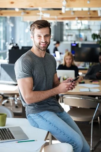 An example of a man wearing casual office dress code. This less formal dress code allows for a more relaxed style that flows with maximum personal expression. It is common in remote workplaces and some retail environments. Jeans, t-shirts, sneakers, and other casual clothing are acceptable