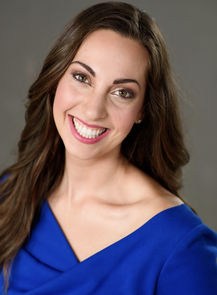 a woman smiling with her shoulder slightly lowered down