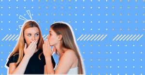 The two girls are whispering to each other.